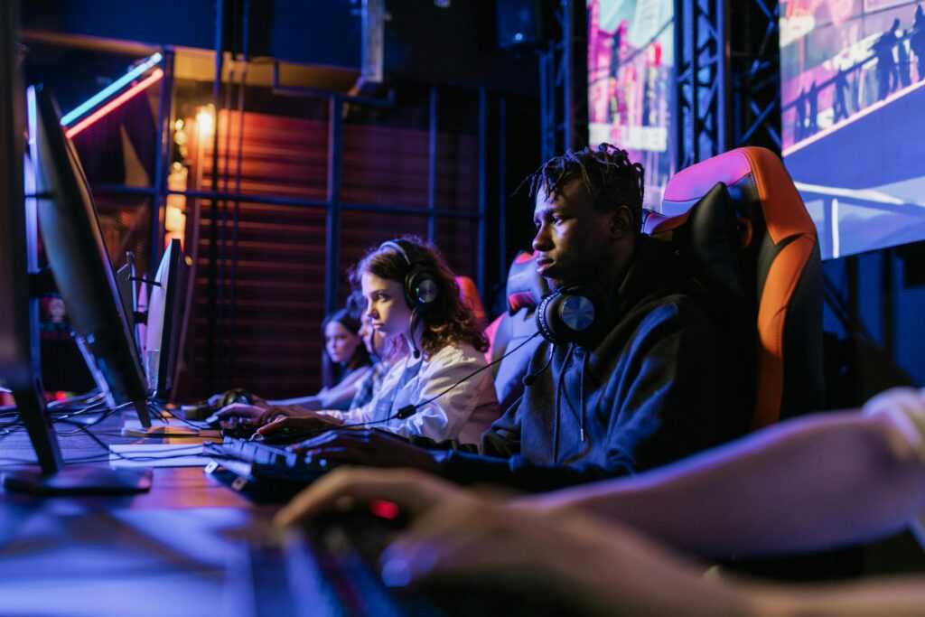 Serious gamers engage in a competitive esports event, highlighting focus and teamwork.
